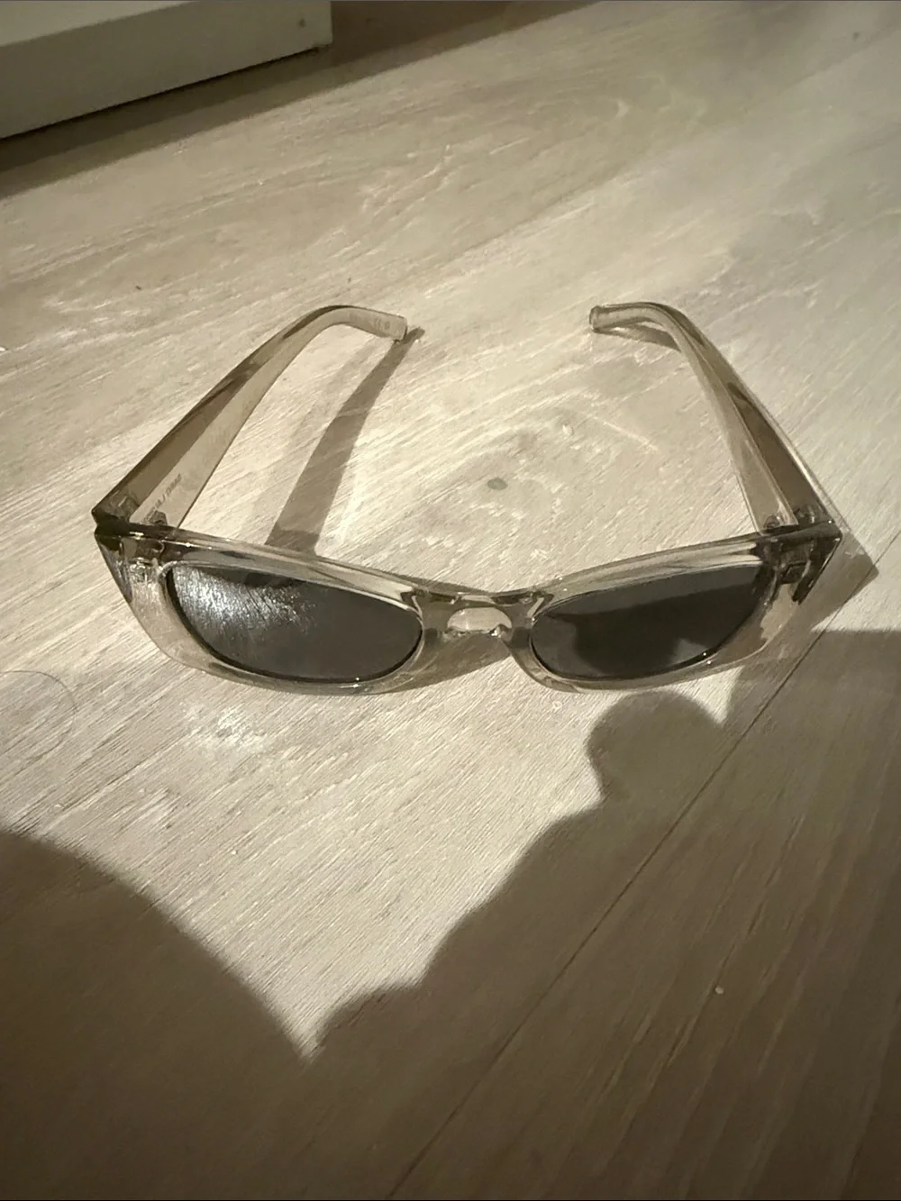 Saint Laurent Transparent Frame Sunglasses with Black Lenses